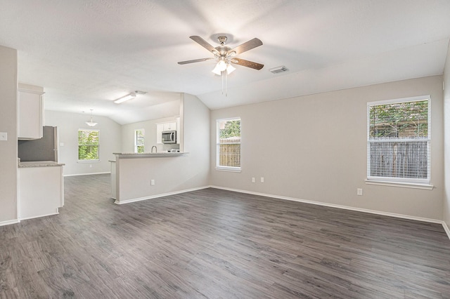 24134 Griffin House Ln, Katy, TX 77493 - unfurnished living room featuring lofted ceiling, dark wood-style floors, and a ceiling fan