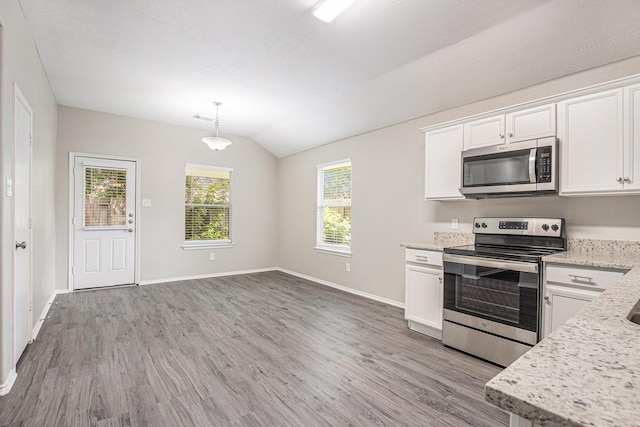 24134 Griffin House Ln, Katy, TX 77493 - kitchen featuring stainless steel appliances, light wood finished floors, lofted ceiling, white cabinets, and hanging light fixtures