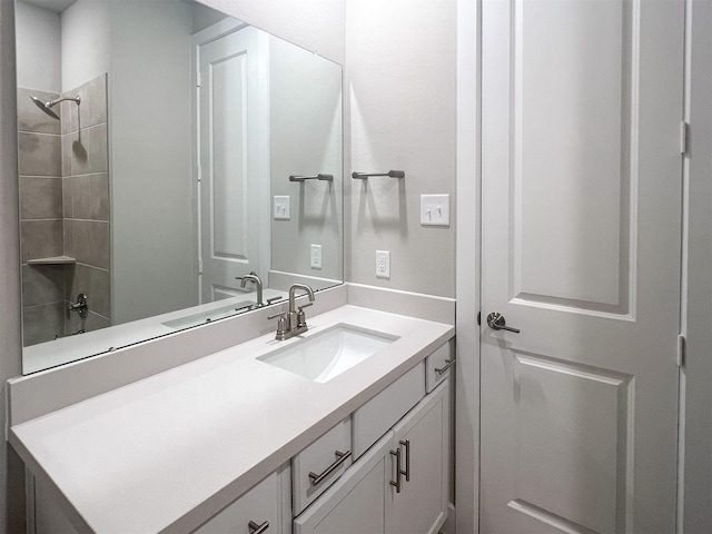 bathroom with a shower and vanity