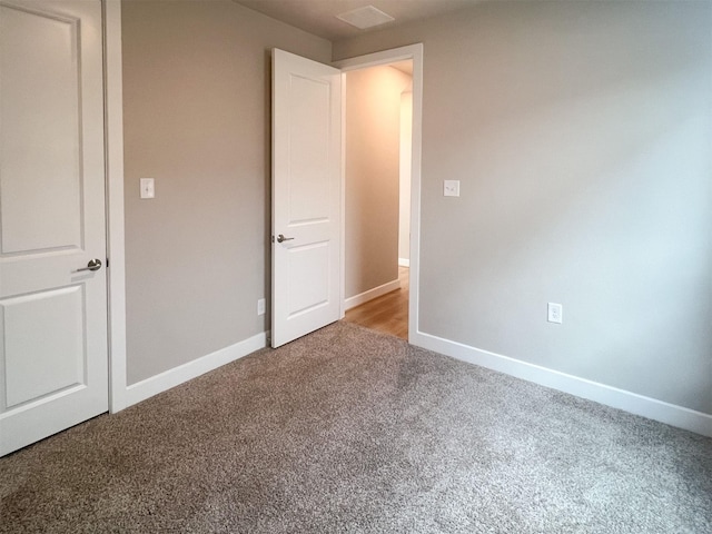 unfurnished bedroom featuring carpet and baseboards