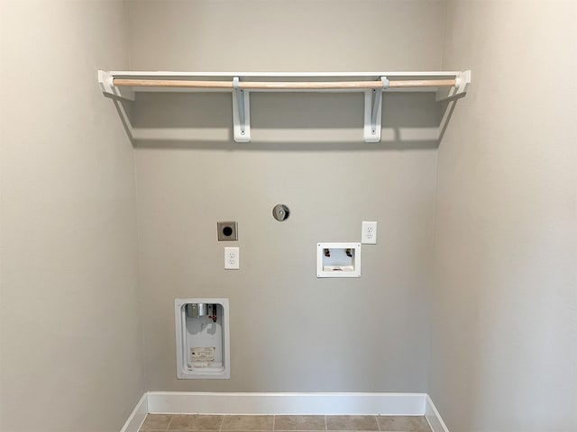 laundry area featuring gas dryer hookup, hookup for an electric dryer, laundry area, washer hookup, and baseboards