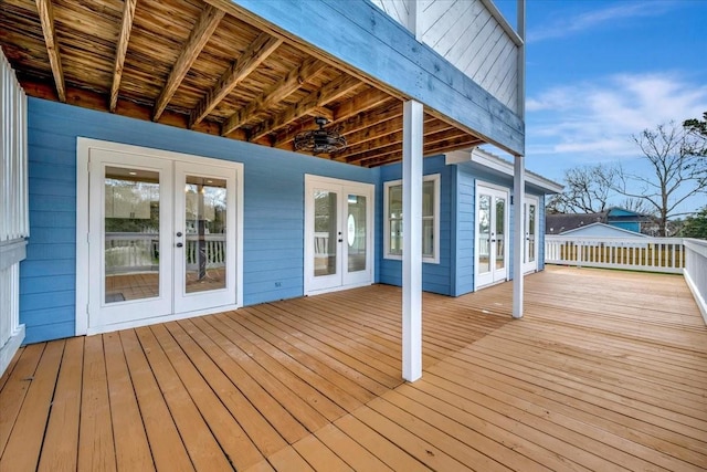 wooden deck featuring a ceiling fan and french doors