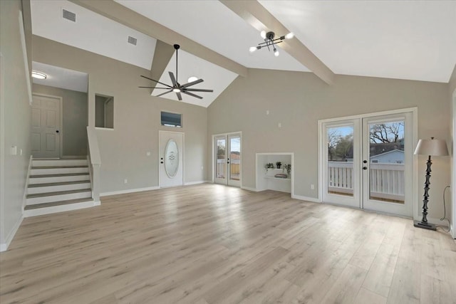 unfurnished living room with light wood finished floors, visible vents, stairway, and french doors