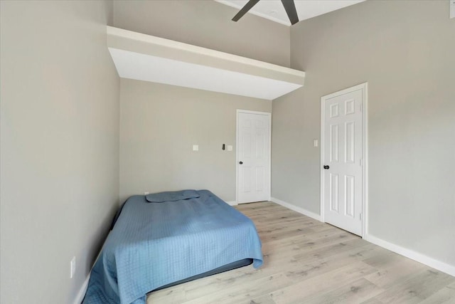 bedroom featuring ceiling fan, baseboards, and wood finished floors