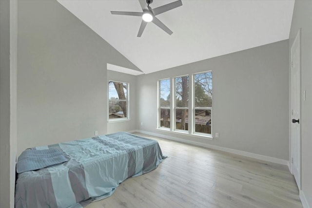 bedroom featuring high vaulted ceiling, ceiling fan, baseboards, and wood finished floors