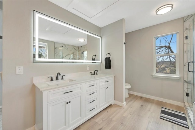 bathroom with a wealth of natural light, a marble finish shower, and a sink