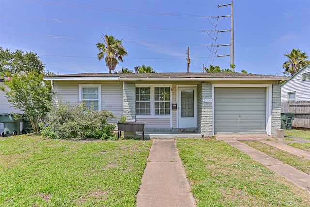 2009 Neumann Dr, Galveston, TX 77551 - view of front facade with a front yard, driveway, and an attached garage