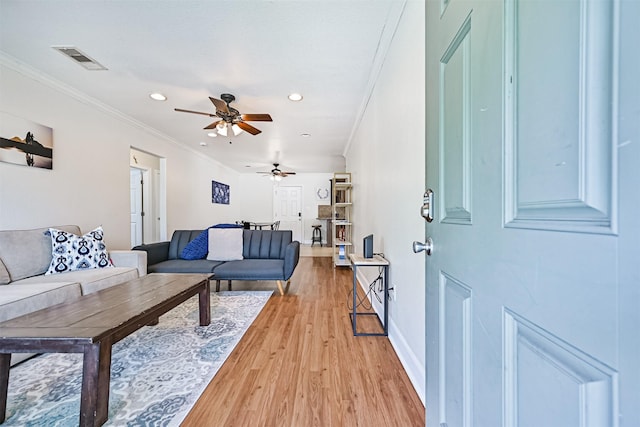 2009 Neumann Dr, Galveston, TX 77551 - living area featuring light wood-style floors, a ceiling fan, ornamental molding, recessed lighting, and baseboards