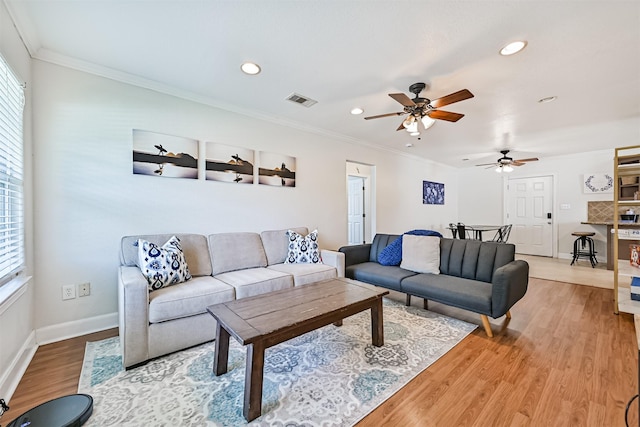 2009 Neumann Dr, Galveston, TX 77551 - living room featuring healthy amount of natural light, a ceiling fan, recessed lighting, light wood-type flooring, and baseboards