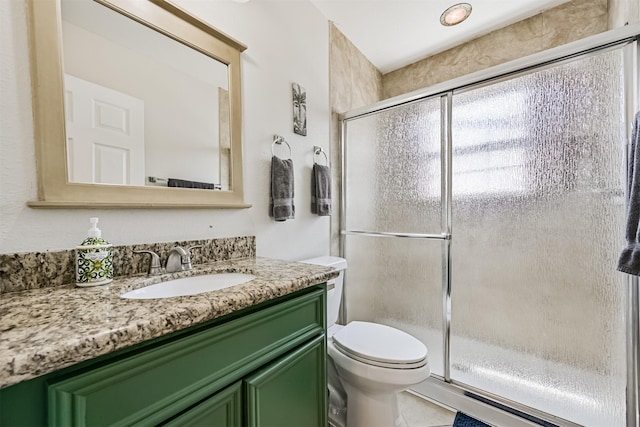 2009 Neumann Dr, Galveston, TX 77551 - bathroom with vanity, an enclosed shower, toilet, and tile patterned flooring