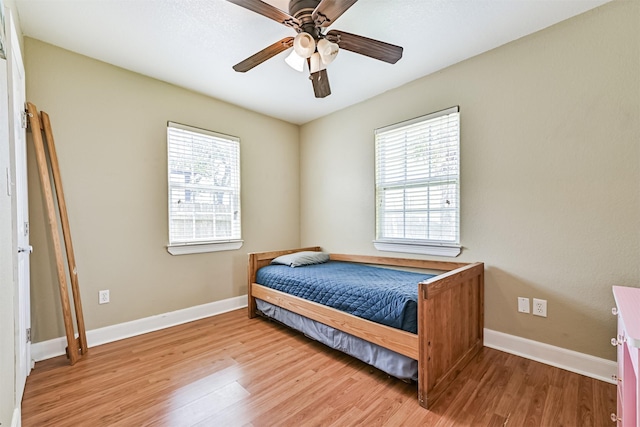 2009 Neumann Dr, Galveston, TX 77551 - bedroom with multiple windows, wood finished floors, and baseboards