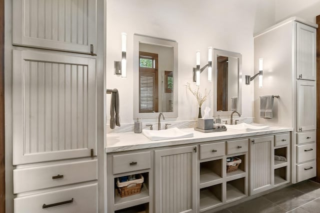 full bathroom featuring double vanity, tile patterned flooring, and a sink