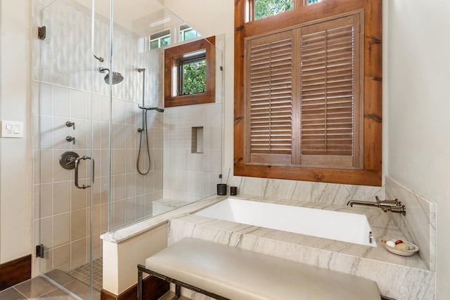 full bathroom with a stall shower and a garden tub