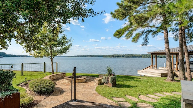 water view featuring an outdoor fire pit and a boat dock