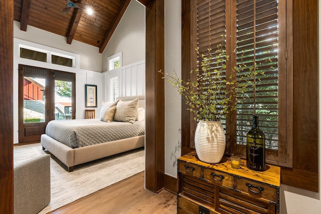 bedroom with wooden ceiling, high vaulted ceiling, beamed ceiling, and wood finished floors