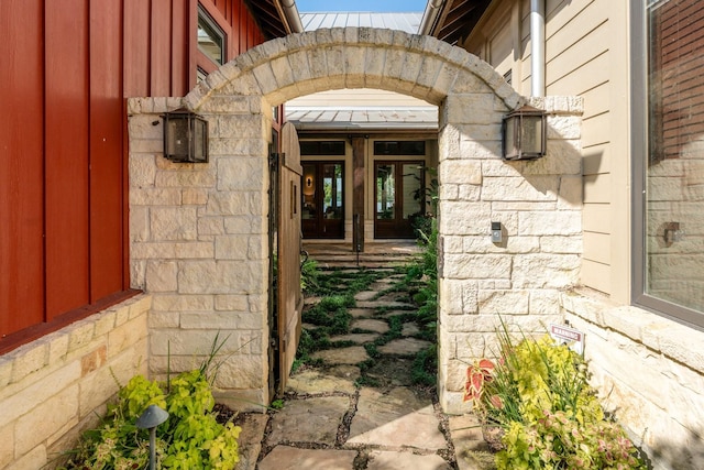 entrance to property with stone siding and french doors