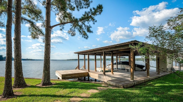 view of dock with a lawn, a water view, and boat lift