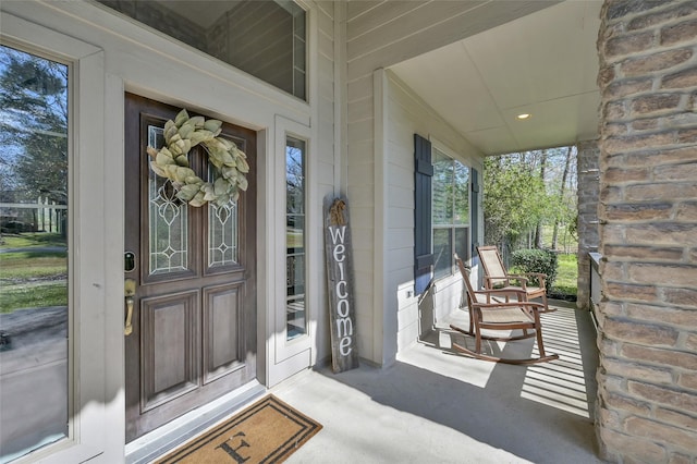 view of exterior entry with covered porch