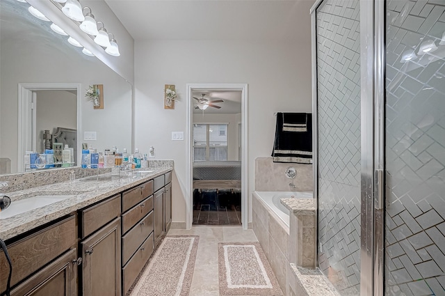 ensuite bathroom featuring double vanity, a garden tub, a sink, and ensuite bathroom