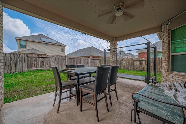 view of patio featuring outdoor dining space, a fenced backyard, and ceiling fan