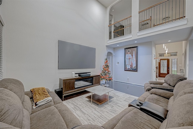 living room with arched walkways and a high ceiling