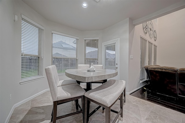 dining room featuring baseboards and recessed lighting