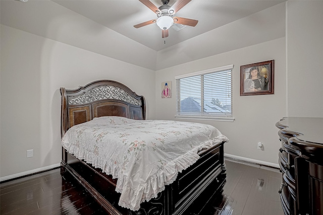 bedroom with lofted ceiling, dark wood-style floors, baseboards, and a ceiling fan