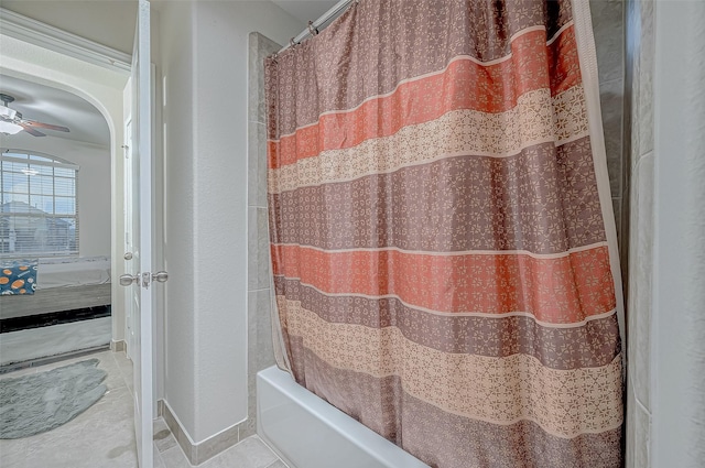 ensuite bathroom with tile patterned floors, shower / tub combo with curtain, and ensuite bathroom