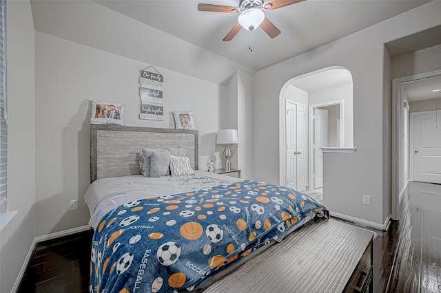 bedroom with attic access, baseboards, ceiling fan, and wood finished floors