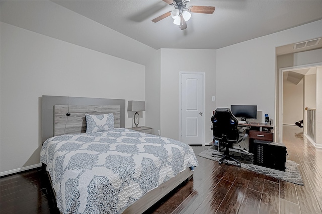 bedroom with a ceiling fan, visible vents, baseboards, and wood finished floors