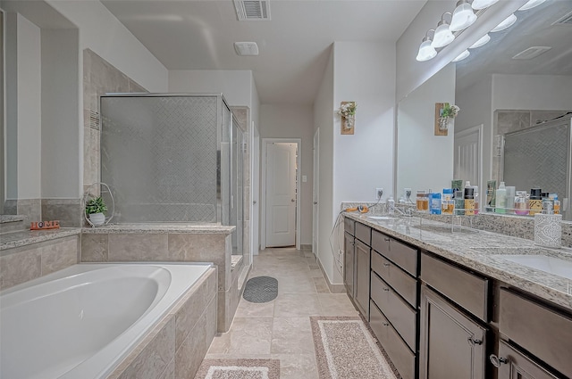 bathroom with double vanity, a shower stall, visible vents, and a bath