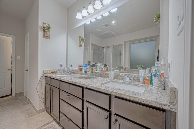 bathroom featuring double vanity, a sink, visible vents, and a shower stall