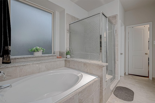 full bath featuring a garden tub and a shower stall