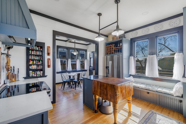 dining room featuring ornamental molding and light wood-type flooring