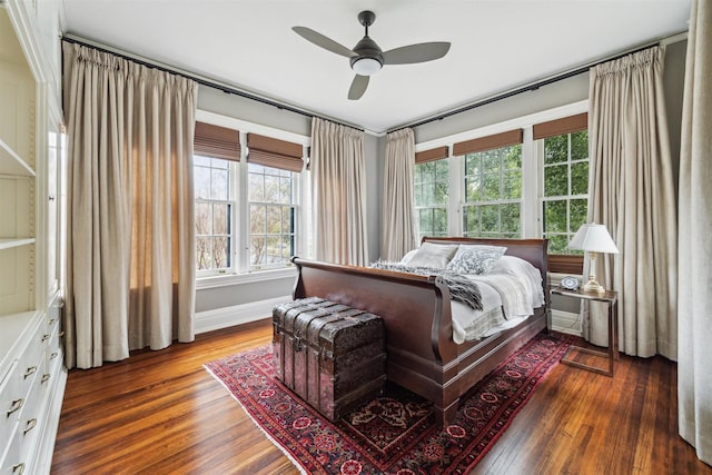 bedroom featuring ceiling fan, baseboards, and hardwood / wood-style flooring