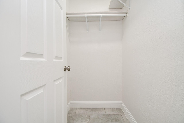 spacious closet with light tile patterned floors