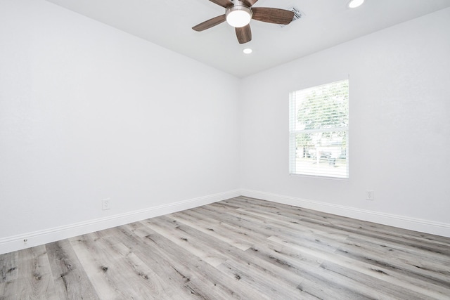 spare room with a ceiling fan, recessed lighting, baseboards, and wood finished floors