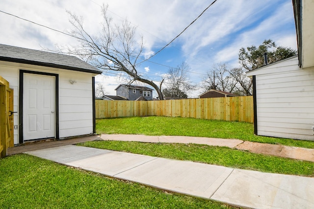 view of yard featuring an outbuilding and a fenced backyard