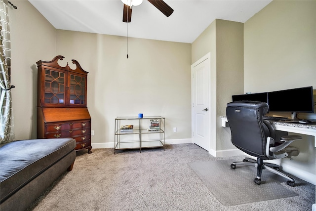 carpeted home office with a ceiling fan and baseboards