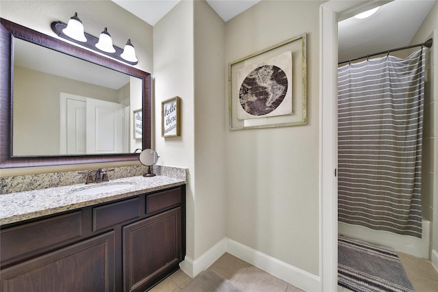 bathroom featuring tile patterned flooring, vanity, and baseboards