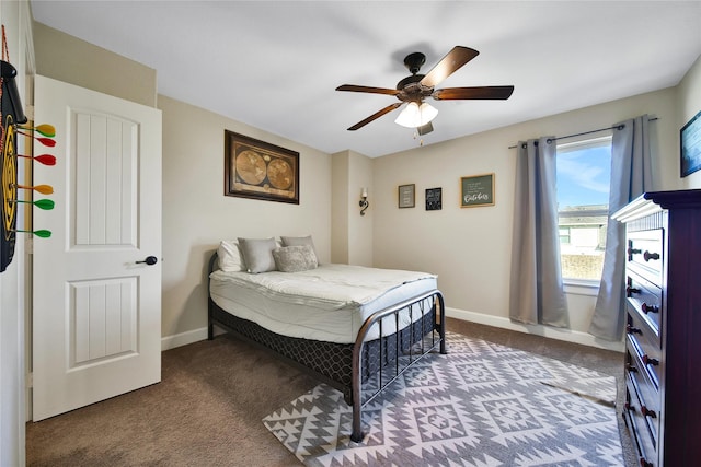 carpeted bedroom with ceiling fan and baseboards