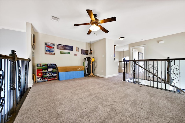 playroom with carpet, visible vents, ceiling fan, and baseboards