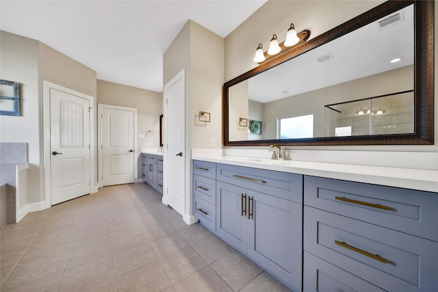 full bathroom featuring visible vents, a tile shower, vanity, and tile patterned floors