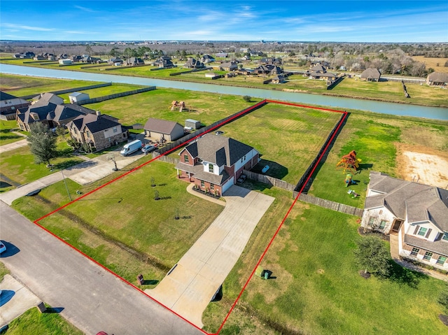 birds eye view of property featuring a water view and a residential view