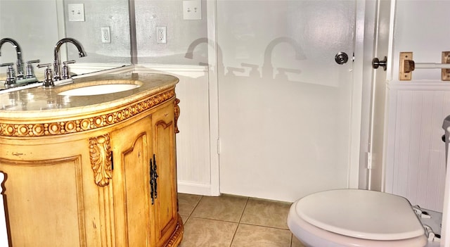 bathroom featuring wainscoting, vanity, and tile patterned floors