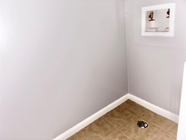 laundry room featuring washer hookup, laundry area, baseboards, and tile patterned floors