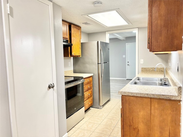 kitchen with brown cabinetry, electric stove, light countertops, a sink, and exhaust hood