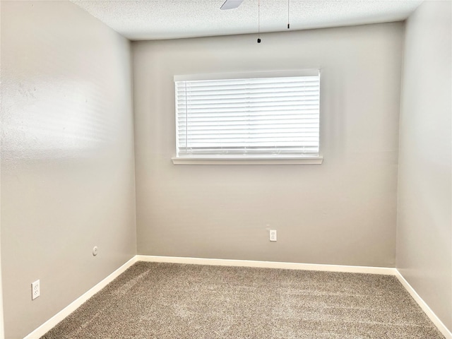 unfurnished room with a textured ceiling, carpet, a ceiling fan, and baseboards