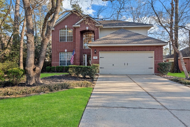 traditional-style house with driveway, brick siding, roof with shingles, an attached garage, and a front yard