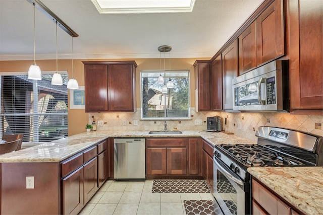 kitchen featuring a peninsula, a sink, ornamental molding, appliances with stainless steel finishes, and tasteful backsplash